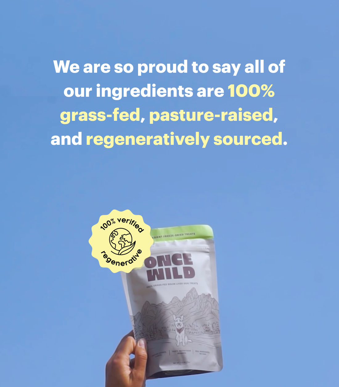 Hand holding a 'Once Wild' product package with text about ingredient sourcing on a blue background. "We are so proud to say all of our ingredients are 100% grass-fed, pasture-raised, and regeneratively sourced."