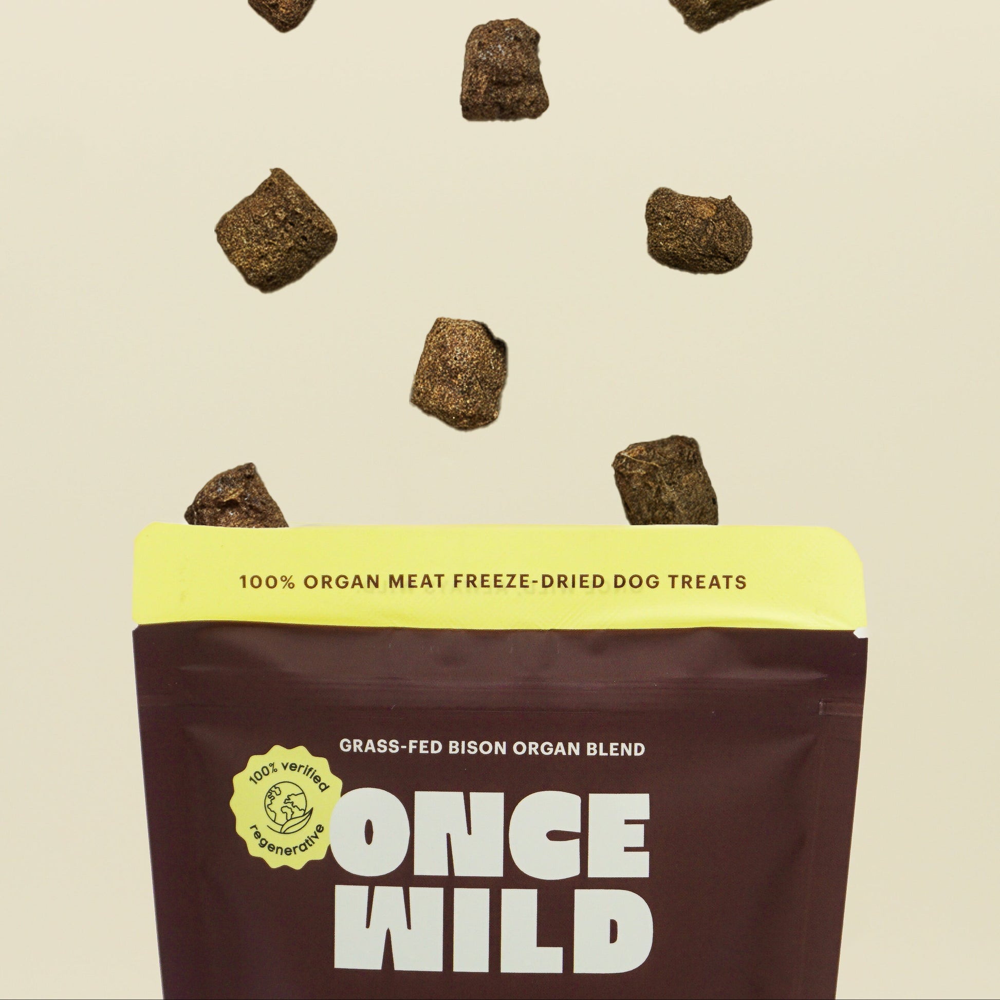 Once Wild dog treat package with freeze-dried treats on a beige background